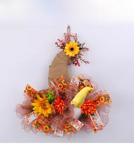 Detail view of mesh gnome autumn wreath with sunflowers and burlap hat for harvest decor