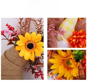 Detailed close-up of artificial sunflower wreath with burlap base and orange mesh ribbon