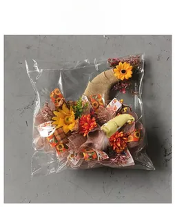 Detail view of the autumn sunflower wreath with gnome decor in clear plastic packaging