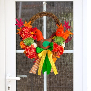 Fall wreath with turkey, maple leaves, and hydrangea on a rustic grapevine base
