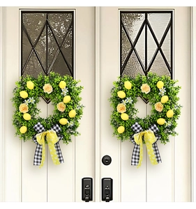 Detail of square lemon wreath with green leaves, yellow roses, and a plaid bow on white door
