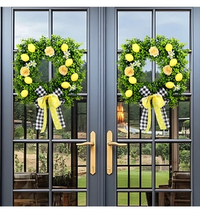 Close-up of artificial lemon wreath with yellow roses and black-white checkered bow decor