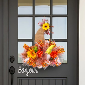 Fall mesh wreath with sunflowers and gnome on rustic burlap for harvest door decor