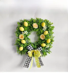 Detail of square lemon wreath with green leaves, pink roses and black-white plaid bow