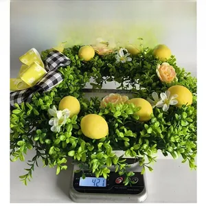 Detail shot showing the 421g weight of the faux lemon wreath on a digital scale