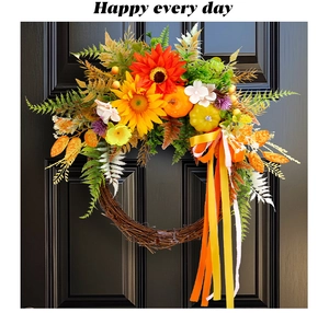 Macro detail of sunflower wreath with small pumpkins and festive ribbon on a door