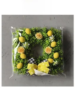 Detailed view of the square lemon wreath with a yellow bow in its protective packaging
