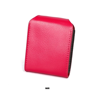 Macro detail of red pebbled leather card holder back with brown monogram fabric lining