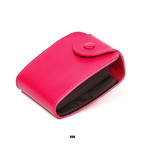 Detail view of pink leather accordion card holder with multiple slots and snap button