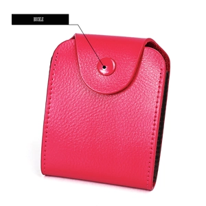 Close-up of bright pink lychee grain leather card holder with secure metal buckle closure
