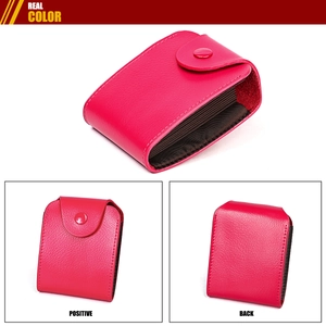 Macro detail of rose red lychee leather card holder with accordion slots and snap button