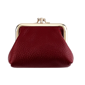 Detailed view of burgundy pebble leather surface and golden kiss-lock metal closure