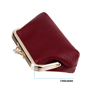 Detail view of burgundy pebble leather coin purse with double kiss-lock gold frames
