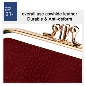 Detail of durable cowhide leather texture on a dark red purse with gold metal frame