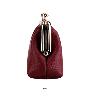 Side view of vintage wine red leather coin purse with classic golden metal frame clasp