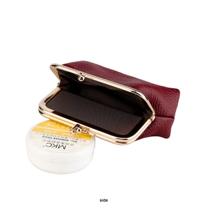 Detailed close-up of wine red litchi grain leather coin purse with vintage gold clasp