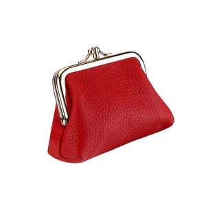 Detail view of red lychee grain leather coin purse with golden metal kiss-lock closure