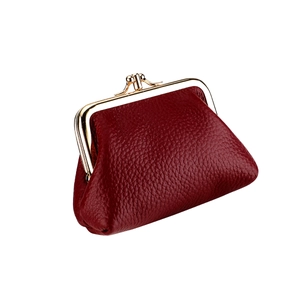 Close-up of wine red pebbled leather coin purse with vintage gold kiss-lock frame