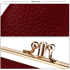 Detail of dark red lychee texture leather and vintage golden metal kiss lock closure