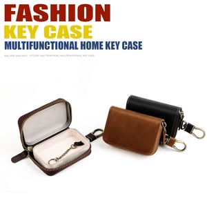 Detail view of leather key case interior showing metal chain and zipper closure