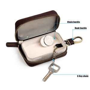 Detail of vintage brown leather key case featuring 6-key chain and metal inner tray