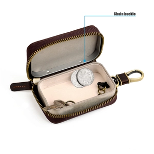 Detail of dark brown crazy horse leather car key case with metal chain buckle and snap hook