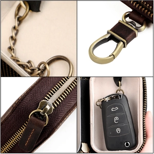 Detail view of leather key case features vintage metal hook and secure interior anti-lost chain