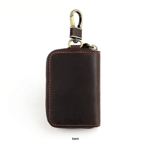 Detail of dark brown crazy horse leather car key case with vintage bronze metal buckle