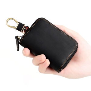 Compact black leather car key case with orange stitching and brass carabiner hook
