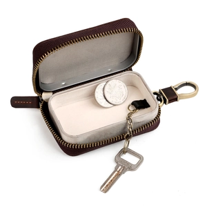 Deep brown leather car key case with aluminum frame and gold zipper shown at 45 degrees