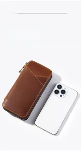 Detail of crazy horse leather pen case with zipper next to smartphone for scale