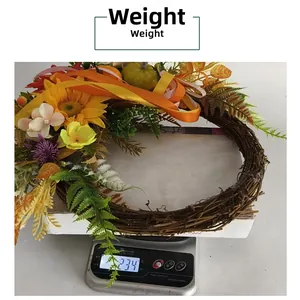 Autumn wreath with sunflowers and pumpkins weighing 234g on a digital scale