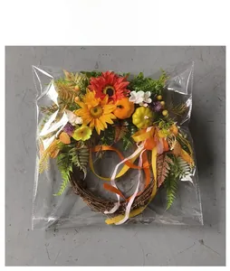 Detail of autumn wreath with sunflowers and pumpkins packed in clear protective packaging