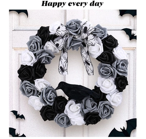 Gothic Halloween wreath detail featuring black roses, striped bow and black crow