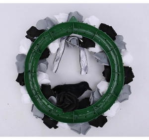 Detail of Halloween wreath back view showing green plastic frame and faux roses
