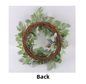 Detail view of the natural rattan back and artificial eucalyptus leaves on the wreath