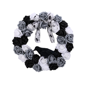 Halloween wreath with black and white roses, crow decoration, and spider web bow ornament