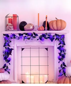 Detail of Halloween garland with purple roses, black leaves and purple LED fairy lights