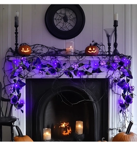 Detail of purple artificial rose garland with LED lights for Halloween mantel decor