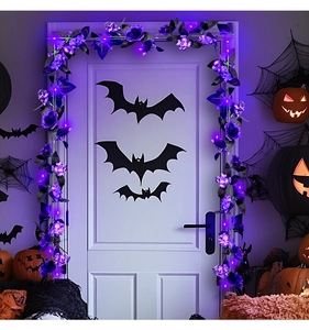 Detail of purple artificial rose vine with LED lights on a door for Halloween decoration