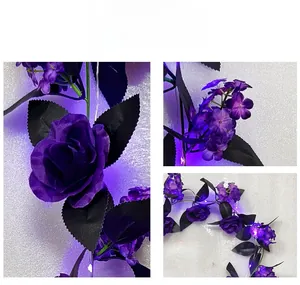 Close-up of purple faux roses with black leaves and purple LED lights for Halloween decor