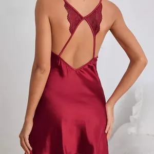 Detail of red faux silk backless sleepwear with intricate lace crisscross and satin finish