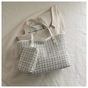 Détail du sac cabas en tweed et sa mini pochette avec des rivets dorés sur veste