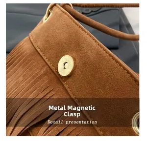 Close-up of the golden hardware magnetic buckle on the brown suede bucket bag