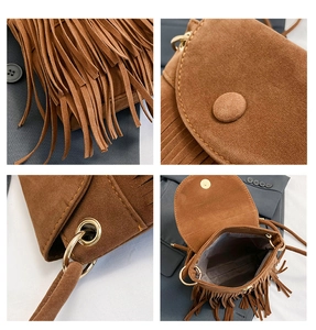 Detail of brown suede bucket bag featuring long fringe, metal rings and magnetic closure