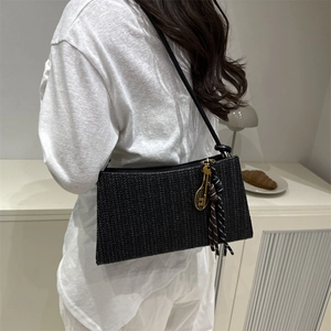 Chic black woven straw shoulder bag for women with gold tennis racket charm