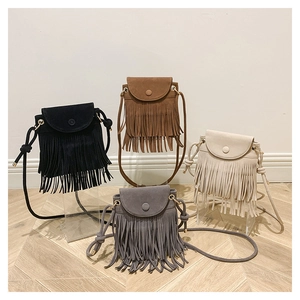 Detail shot of four tassel bucket bags in black, brown, cream, and grey suede material