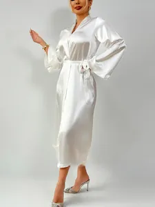 Detailed view of white silk satin long-sleeve bathrobe with elegant waist tie and V-neck