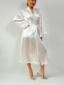 Detail of white long-sleeved satin robe with V-neckline and matching belt for women
