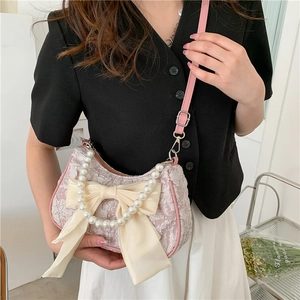 Pink lavender textured handbag with oversized cream bow and elegant pearl handle strap